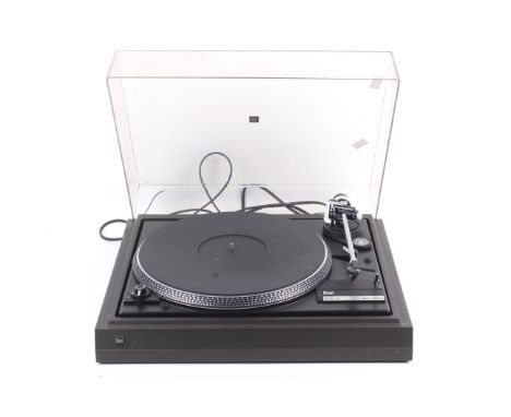 A vintage Dual CS 505-2 record deck turn table. With an Ortofon 10 cartridge and plastic dust cover. L43cm x D37cm x H14cm