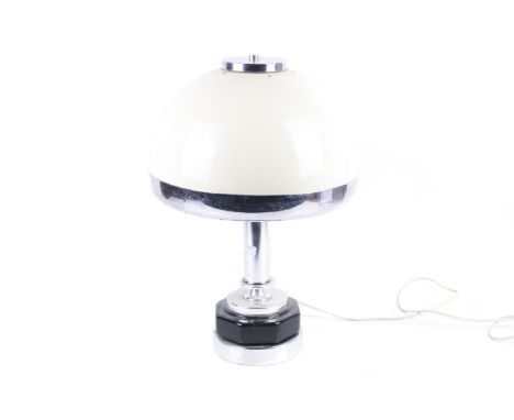 A mid-century table lamp. The domed cream plastic shade with a chrome rim and top, mounted on a chrome stand and an octagonal