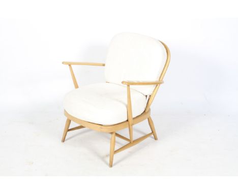 A circa 1980 Ercol 334 Windsor easy open arm chair. With blonde elm stick back and supports united by a H shaped stretcher, H