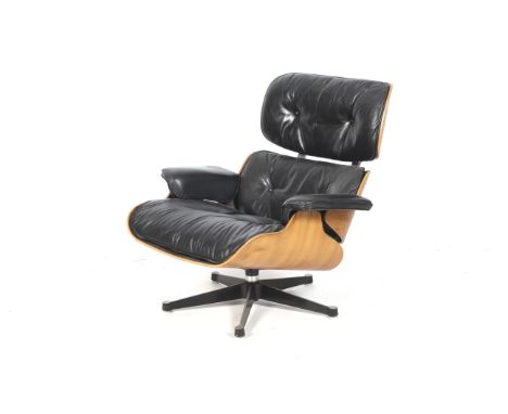 A Charles & Ray Eames for Herman Miller lounge chair model 670.  Laminated plywood veneer frame with black leather button uph