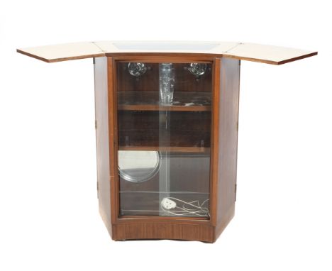 A 'Turnidge' mid-century teak drinks cabinet. The bow front having two full length doors, with a shelved interior and fitting