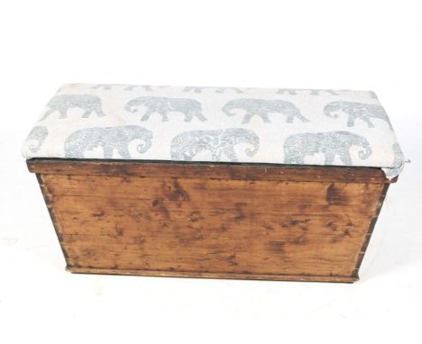 A vintage pine chest. Having a hinged upholstered lid, opening to reveal a green fabric lined interior, on block feet. H60cm 