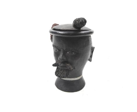 A vintage novelty black pottery tobacco jar and cover. Of a South African Zulu chief. H19cm