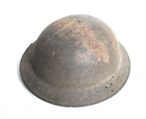 A WWII British Army Home Front helmet, dated 1941. Marked 'BMB 1941' (Briggs Motor Bodies Ltd of Dagenham), with three holes 