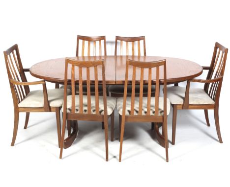 A vintage style oval extendable table and six chairs. The two carvers and four chairs with slatted backs and beige padded uph