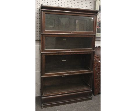 A early 20th century oak Globe Wernicke. Four tiers, two with glazed doors, three sections bear plaques, H152cm x W86.5cm x D