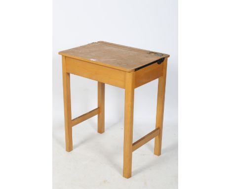 A vintage Marmet elm school desk. With an inkwell and pen tray to the top, having a hinged lid, raised on square supports uni