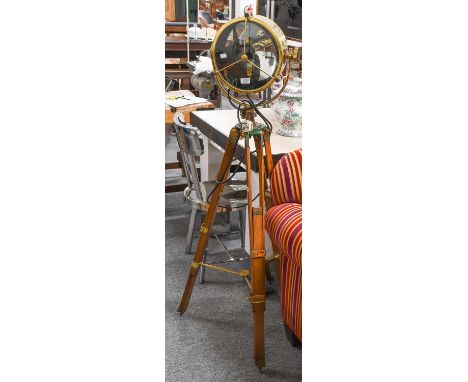 A Brass Adjustable Search Light, on wooden tripod stand, makers Francis Search Lights Ltd, converted to a standard lamp, 148c