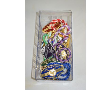 SMALL PLASTIC BOX CONTAINING ENAMEL BADGES, SOME FROM GT YARMOUTH RACE COURSE