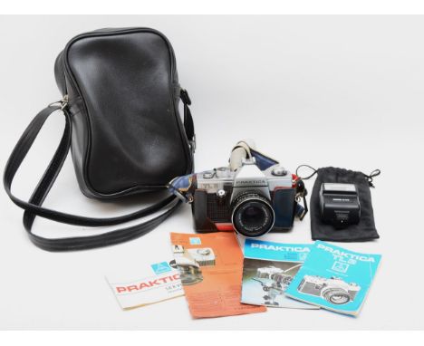 A Praktica TL3 SLR camera, Tessar 2.8/50 lens, instruction booklets, hard case and Sunpak flash lamp 