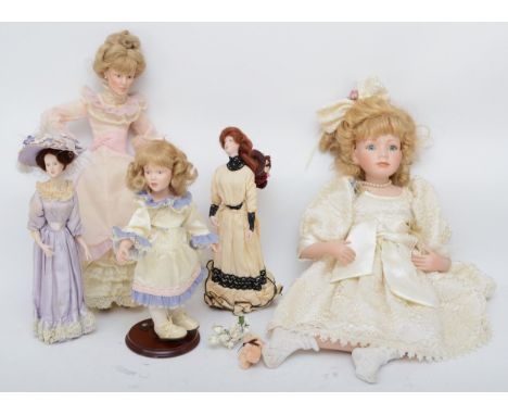 Five mid 20th century and later porcelain bisque head dolls, with hair, open eyes, open mouth, composite body, in original cl