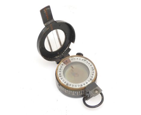 A WWII British military compass, by T.G.Co Ltd, London, numbered 43557, broad arrow, 1940, MkIII, with leather carry case. 