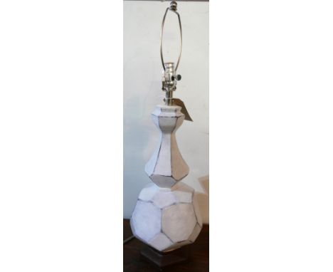 A white ceramic lamp base of facetted bulbous shape, H.72cm 