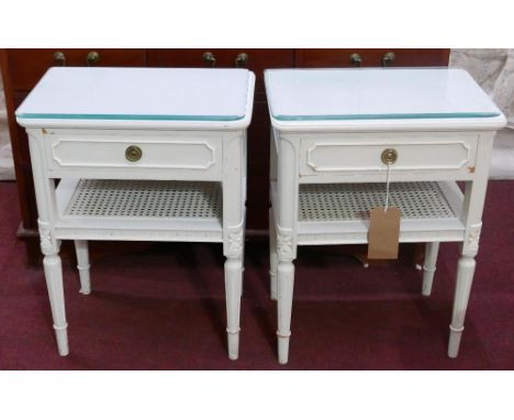 A pair of wooden white-painted Provencal style bedside tables with glass tops with upper drawer and lower bergere shelf, 58 x