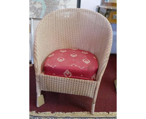 A pink Lusty Lloyd Loom tub chair 