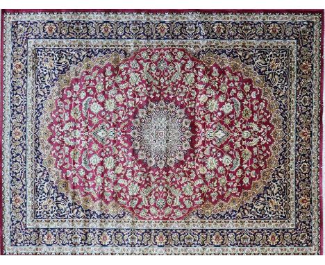 A Kashan style carpet with central floral medallion, on a red ground, contained by floral borders, 230 x 160cm 