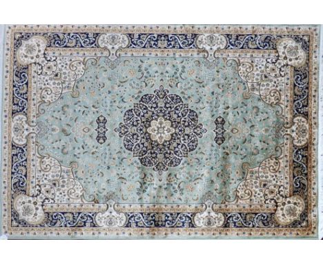 A Kashan style carpet with central floral medallion, on a green ground, contained by floral borders, 230 x 160cm 