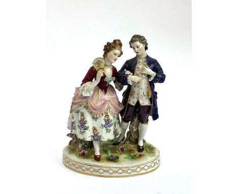 An early 20th century Capodimonte porcelain figure group of a lady and gentleman (af), 20cmH