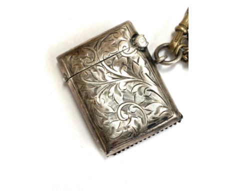 A small early 20th century silver vesta case, 4cmL, hallmarked for William Hair Haseler, Birmingham, 1913; on a gilt metal fo