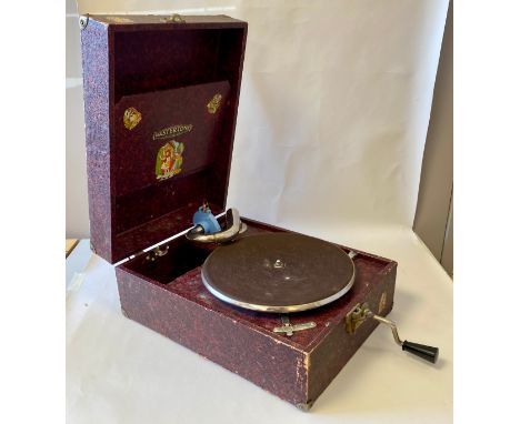 AN OLD PORTABLE GRAMOPHONE. 'Mastertone', Made in England. With a box of 78s. These include a few items (Stan Kenton for exam