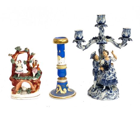 A German porcelain figural candlestick (af), Sitzendorf style mark to base; together with a Staffordshire flatback figure and
