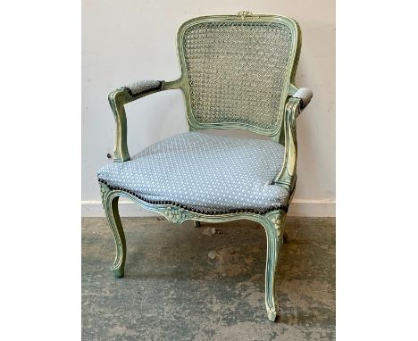 A painted fauteuil or open armchair, 20th century, with caned back over upholstered seat and arms
