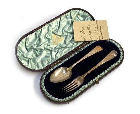 A cased silver fork and spoon christening set by Howell &amp; James Ltd, Sheffield 1886, 2.1ozt; together with a cased napkin