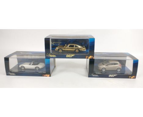 Three MINICHAMPS 1:43 scale models from the James Bond collection to include a limited edition number 1432 of 2016 GOLD ASTON