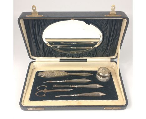 A SILVER BIRMINGHAM hallmarked pedicure set within its original black silk lined box with mirrored back (the only non silver 