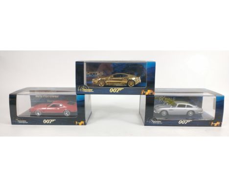 Three MINICHAMPS 1:43 scale models from the James Bond collection to include a limited edition number 0149 of 2016 GOLD ASTON