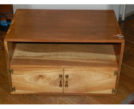 An Indonesian hardwood handmade coffee/TV unit, having open shelf above two cupboard doors. H.46cm W.77cm D.49cm