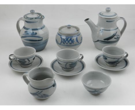 A Crowan pottery tea service, decorated with brush strokes of blue on a pale grey ground, to include four cups, three saucers