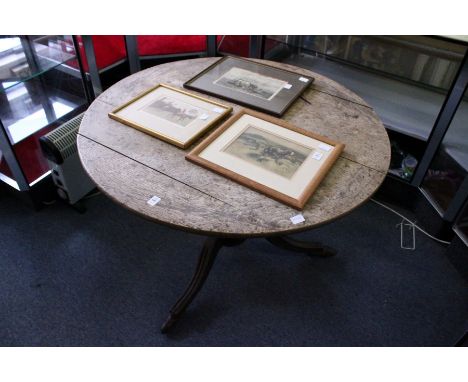 An oak circular tilt top tripod table