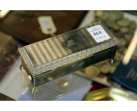 A rectangular silver box with engine turned lid