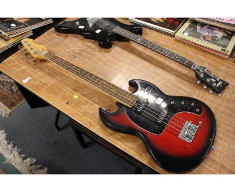 An unbranded short-scale electric bass guitar with zero fret and two single coils. Lacking knobs and bridge cover. 30" scale,