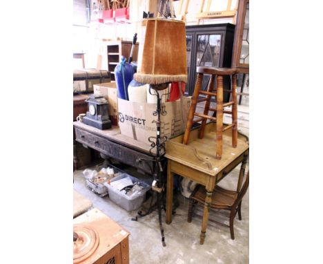 A wrought iron telescopic standard lamp