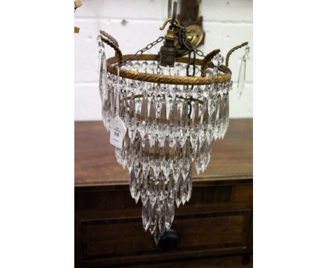 The matching larger brass and cut glass single chandelier