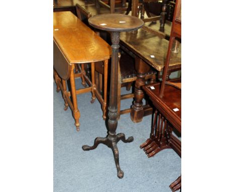 A turned and carved mahogany tripod jardiniere stand