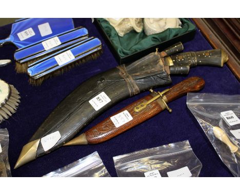 A Kukri with scabbard and another cased knife