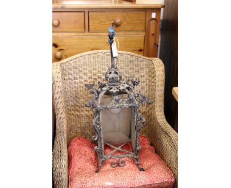 An ornate wrought iron hall lantern