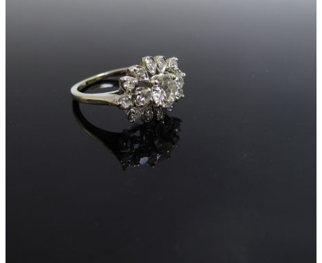 A white gold diamond cluster ring, the central diamond .50ct approximately, size J