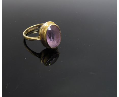 A 9ct gold ring set with central faceted amethyst, size N, 1.1cm long, 3g