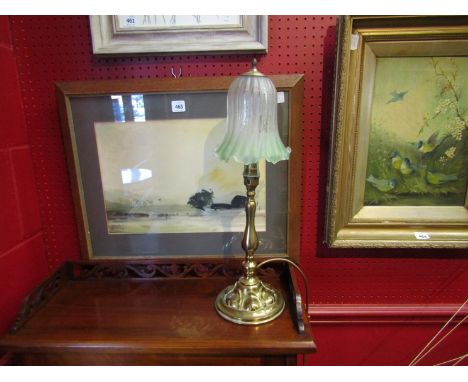 An Art Nouveau brass table lamp with a green and clear ribbed shade, frill edge  