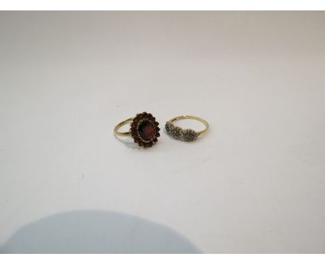 A 9ct gold garnet dress ring, size N, and a 9ct gold champagne and white diamond ring, size P, 5.6g (2)