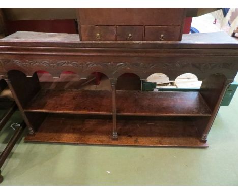 A two shelf oak wall unit with central pillar and carved frieze to top