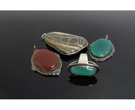 A chrysoprase cabochon ring, similar pendant and two modernistic pendants 