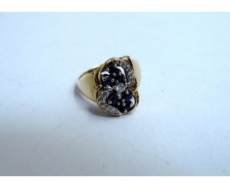 A sapphire and diamond cluster ring stamped 14K, size O, 5.7g    