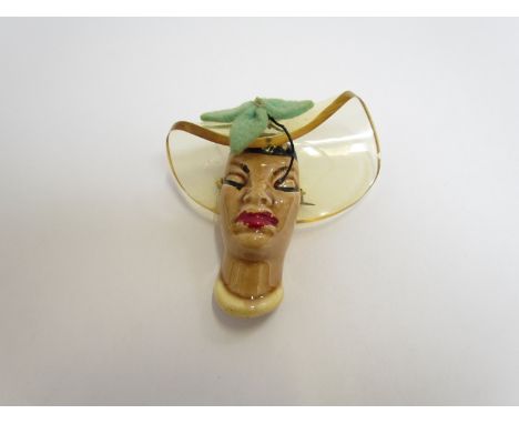 An Elzac ceramic and lucite brooch from the series of 'Victims of fashion' 