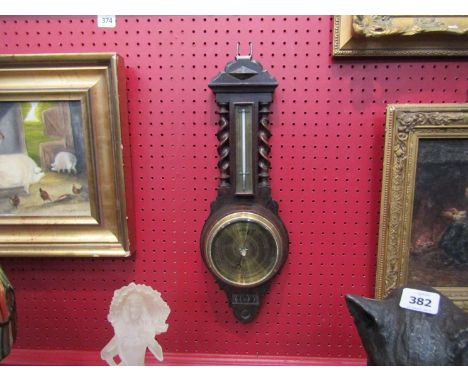 An oak framed barometer with thermometer