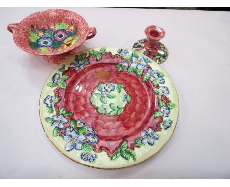 Three pieces of Maling ware consisting of twin handled pedestal bowl, platter and candlestick, green and pinks